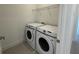 Bright laundry room with a side-by-side washer and dryer and wire shelving at 14046 Scarlet Aster Aly, Winter Garden, FL 34787