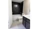 Bathroom featuring dark tiled walls and vanity at 5635 Devonbriar Way # 103, Orlando, FL 32822