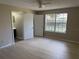 Bedroom featuring new wood flooring and ensuite bathroom access at 5635 Devonbriar Way # 103, Orlando, FL 32822