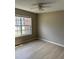 Bedroom with light wood floors and large window for natural light at 5635 Devonbriar Way # 103, Orlando, FL 32822