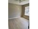 Bright bedroom featuring wood-look flooring, neutral paint, a ceiling fan, and a window with outside view at 5635 Devonbriar Way # 103, Orlando, FL 32822