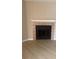 A classic fireplace with a white mantle and tile surround provides a cozy focal point in the living space at 5635 Devonbriar Way # 103, Orlando, FL 32822