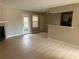 Bright living room featuring wood floors, fireplace, and access to the patio at 5635 Devonbriar Way # 103, Orlando, FL 32822