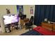 Bedroom featuring a gaming setup with TV, desk, chair, and fun cartoon wall decor at 13103 Mulberry Park Dr # 824, Orlando, FL 32821