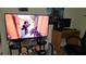 Bedroom gaming setup featuring a TV displaying a video game and cartoon character figures at 13103 Mulberry Park Dr # 824, Orlando, FL 32821