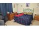 Bedroom features a bed, dresser, and gaming chair at 13103 Mulberry Park Dr # 824, Orlando, FL 32821