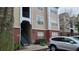 Tan building exterior with red brick accents and green stairs leading to upper units for easy access at 13103 Mulberry Park Dr # 824, Orlando, FL 32821