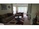 Spacious living room with comfortable seating, a ceiling fan, and natural light from the window at 13103 Mulberry Park Dr # 824, Orlando, FL 32821