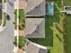 Aerial view of home exteriors in a well-maintained neighborhood with lawns extending to a community lake at 4949 Olivia Ct, St Cloud, FL 34772