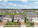 An aerial view shows this home and community featuring water access and lush landscaping at 4949 Olivia Ct, St Cloud, FL 34772