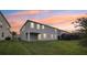 Back of house features neutral paint, covered patio, and grassy lawn at 4949 Olivia Ct, St Cloud, FL 34772