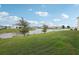 Green backyard with lake view at 4949 Olivia Ct, St Cloud, FL 34772