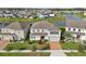A two-story home featuring a brick driveway, a well-manicured lawn, and a gray exterior at 4949 Olivia Ct, St Cloud, FL 34772