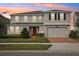 A home features an attached two-car garage, manicured landscaping, and neutral paint at 4949 Olivia Ct, St Cloud, FL 34772