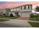 This two-story home features an attached two-car garage and manicured landscaping at 4949 Olivia Ct, St Cloud, FL 34772