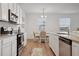 Open kitchen with stainless steel appliances and an adjacent dining area for casual meals at 4949 Olivia Ct, St Cloud, FL 34772