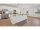 Modern kitchen features stainless steel appliances, granite countertops, and an island with seating at 4949 Olivia Ct, St Cloud, FL 34772