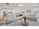 Bright living room featuring neutral furniture, an open floorplan, and modern decor at 4949 Olivia Ct, St Cloud, FL 34772