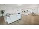 Open-concept living space with modern furnishings, white walls, and kitchen view at 4949 Olivia Ct, St Cloud, FL 34772