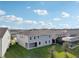 Rear exterior featuring a covered patio with a lawn extending toward a screened in pool and neighboring home at 4949 Olivia Ct, St Cloud, FL 34772