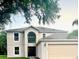 Charming two-story home with a large arched window above the entryway and a two-car garage at 1856 Emily Dr, Winter Haven, FL 33884
