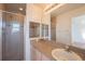 Bathroom with a glass shower and granite topped vanity at 4712 Hemingway House St, Kissimmee, FL 34746