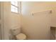 Cozy half bathroom featuring a toilet and small granite topped sink at 4712 Hemingway House St, Kissimmee, FL 34746