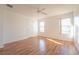 Spacious bedroom featuring two bright windows, ceiling fan and laminated wood-look flooring at 4712 Hemingway House St, Kissimmee, FL 34746