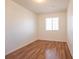 This simple bedroom features wood floors and a window at 4712 Hemingway House St, Kissimmee, FL 34746