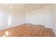 Bright bedroom with laminated wood-look flooring, white walls, and closet and door at 4712 Hemingway House St, Kissimmee, FL 34746