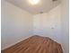A well-lit bedroom featuring wood floors, closet, and bright white walls at 4712 Hemingway House St, Kissimmee, FL 34746