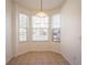 Bright dining area with a pendant light fixture, tile flooring, and bay windows at 4712 Hemingway House St, Kissimmee, FL 34746