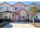 Colorful townhouse exterior showing a well-maintained facade, driveway, and manicured shrubbery at 4712 Hemingway House St, Kissimmee, FL 34746