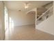 Sun-filled living room featuring tile flooring and an open floor plan with staircase at 4712 Hemingway House St, Kissimmee, FL 34746