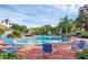 Enjoy this community pool with seating, lush landscaping and tropical palm trees surrounding the area at 4712 Hemingway House St, Kissimmee, FL 34746