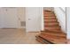 Wooden staircase with white railings and tile flooring near a storage closet at 4712 Hemingway House St, Kissimmee, FL 34746