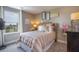 Cozy bedroom with striped bedding and large window at 2933 Mango Tree Dr, Edgewater, FL 32141