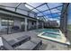 Expansive backyard featuring a screened pool, spa, and multiple seating areas at 2933 Fable St, Kissimmee, FL 34746