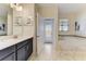Bright bathroom featuring double vanity, soaking tub with jets, and marble flooring with access to the backyard at 2933 Fable St, Kissimmee, FL 34746
