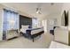 Stylish primary bedroom features a dark headboard, mirrored nightstands, and blue accents throughout the room at 2933 Fable St, Kissimmee, FL 34746