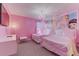 Charming bedroom featuring twin beds, princess-themed decor, and soft pink accents at 2933 Fable St, Kissimmee, FL 34746