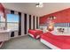 Fun bedroom with two queen beds, black and white striped accent walls, and a Mickey Mouse themed wall at 2933 Fable St, Kissimmee, FL 34746