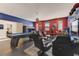 An awesome game room featuring a pool table, gaming chairs, and superhero decorations on the walls at 2933 Fable St, Kissimmee, FL 34746