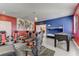 Spacious game room with foosball table, bunk beds, gaming chairs, and superhero decor on the walls at 2933 Fable St, Kissimmee, FL 34746