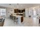 Modern kitchen with dark cabinets, a large center island with seating, and stainless steel appliances at 2933 Fable St, Kissimmee, FL 34746