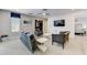 Comfortable living room with a ceiling fan, large window, contemporary furniture, and entertainment center at 2933 Fable St, Kissimmee, FL 34746