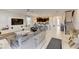 Bright open-concept living room featuring sleek white tile floors and a modern entertainment center at 2933 Fable St, Kissimmee, FL 34746