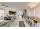 Open-concept living and dining area with modern decor, sleek white tile flooring, and bright lighting at 2933 Fable St, Kissimmee, FL 34746