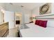 Comfortable main bedroom featuring a plush bed, soft lighting, and a view into the en suite bathroom at 2933 Fable St, Kissimmee, FL 34746