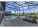 Screened-in pool and spa with a sundeck and serene lake view at 2933 Fable St, Kissimmee, FL 34746